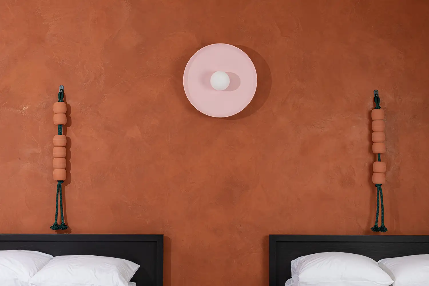 terracotta bedroom wall with two beds