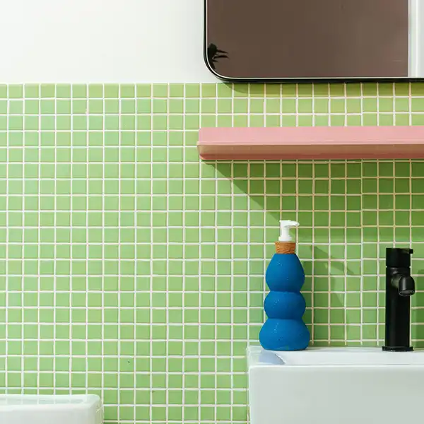 photograph of a green tiled bathroom