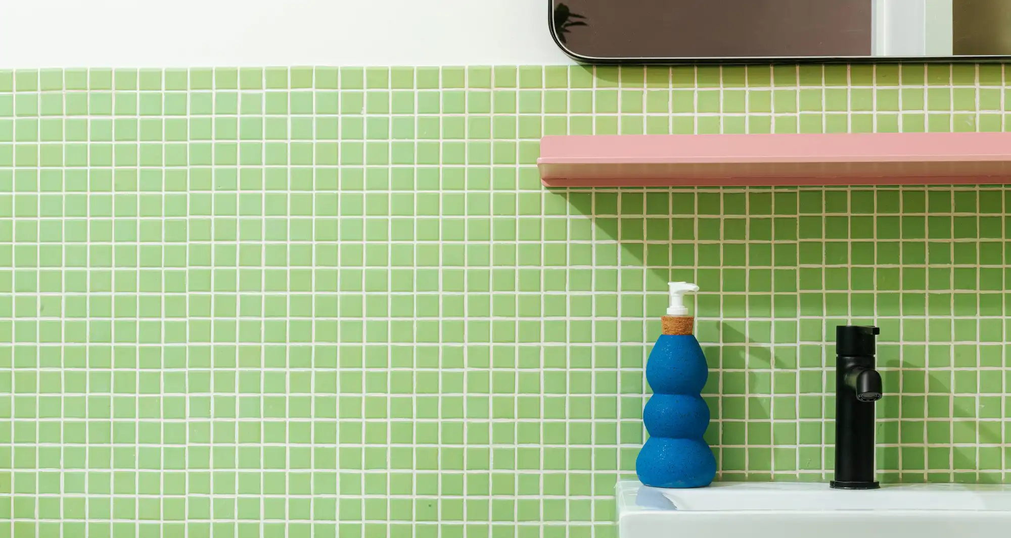 photograph of a green tiled bathroom