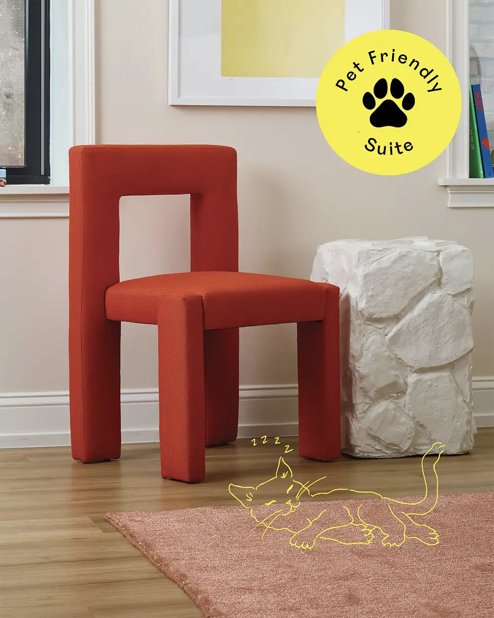 Artistic orange chair against a beige wall with two windows and a stone-like shaped white table and a yellow stamp with the text 