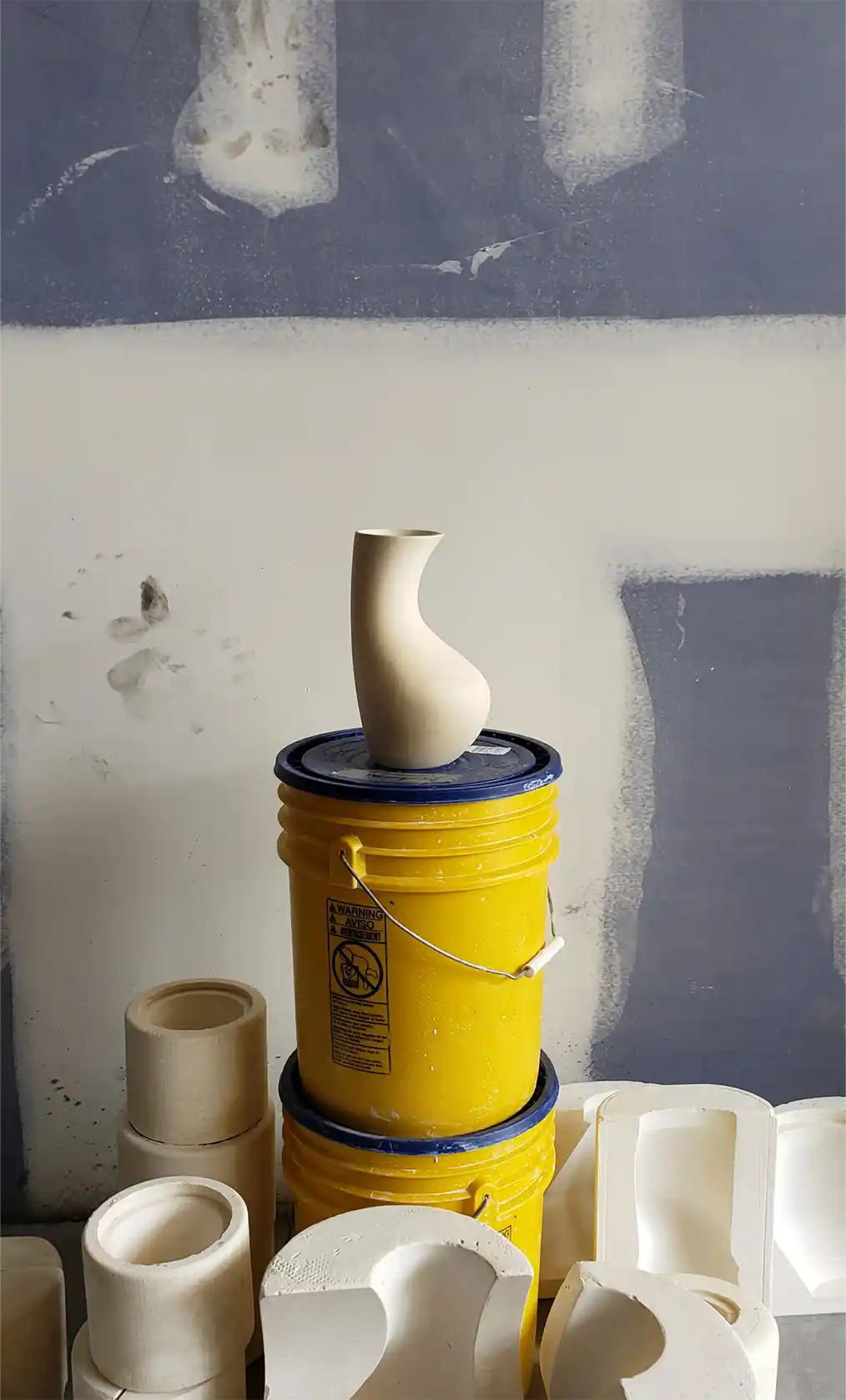 Sculpture made of concrete on top of two paint cans