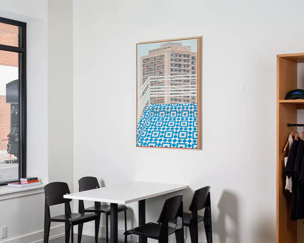 dining room with white table and black chairs with blue decorative painting