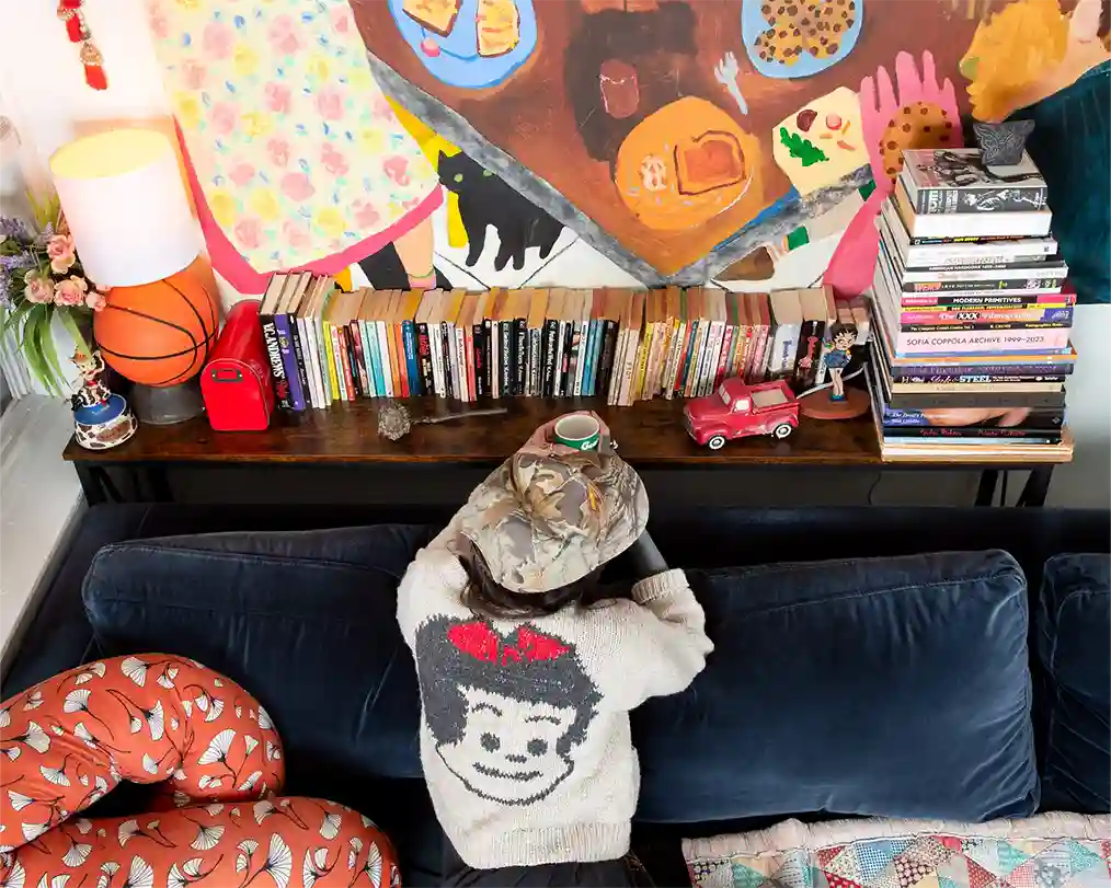 person looking at books on a shelf