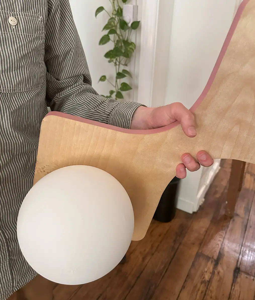 a person holding a wooden lamp