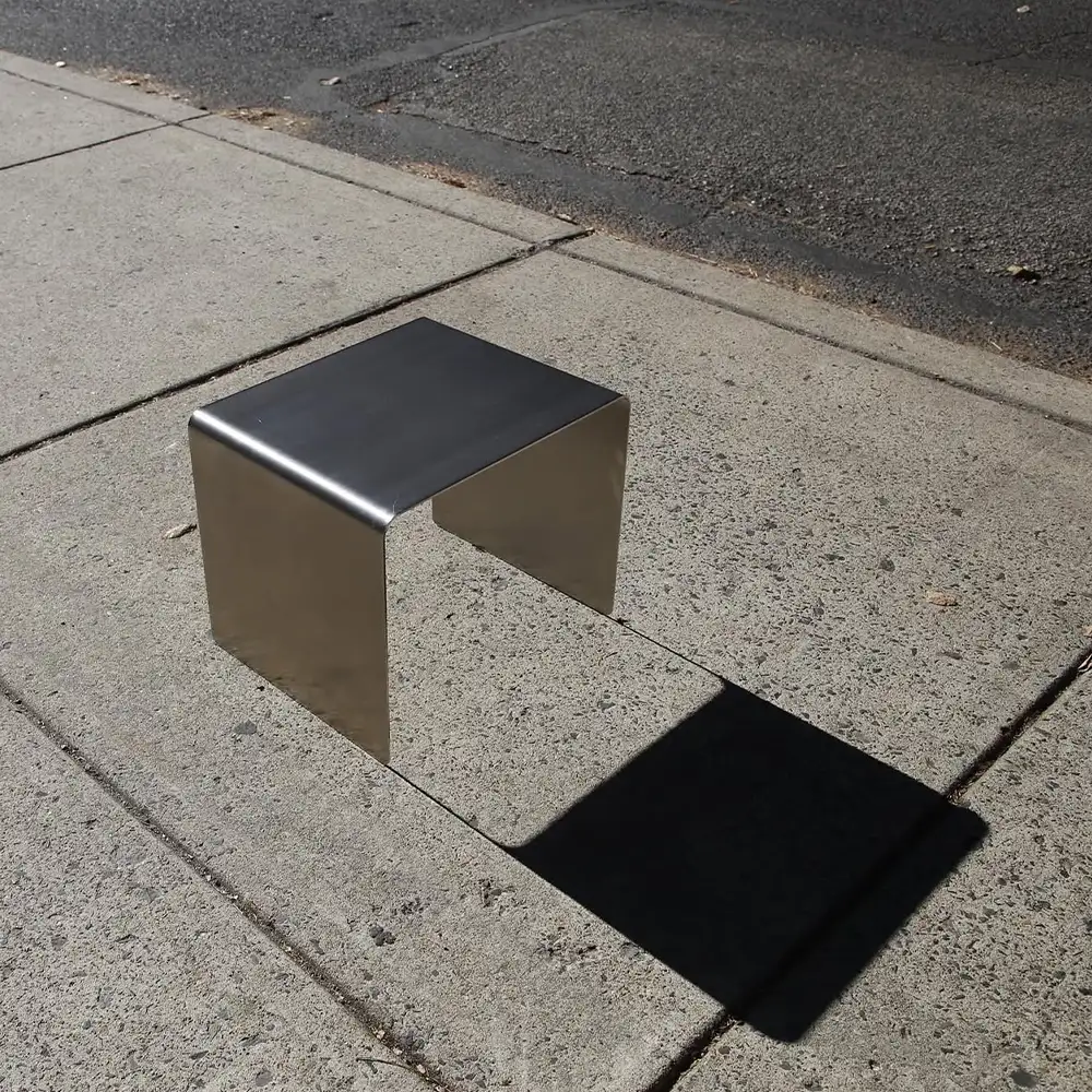 metal armchair in the middle of the street