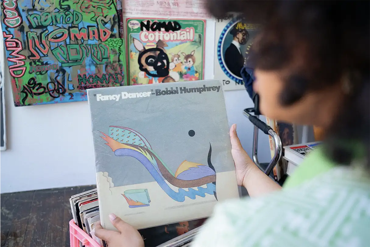 Look over the shoulder of a woman holding the Francy Dancer album by Bobbie Humphrey