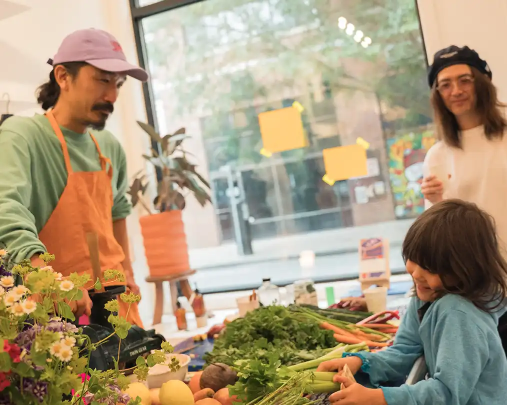 man in a purple cap serving in a flower shop