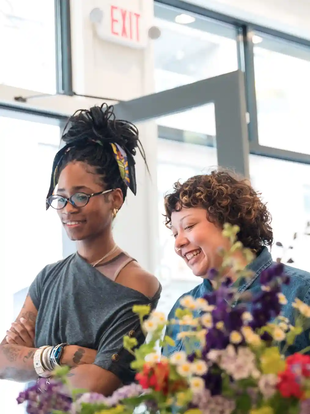 two women surrounded by flowers