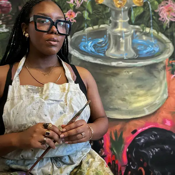 Afro woman with a beautiful mural behind her