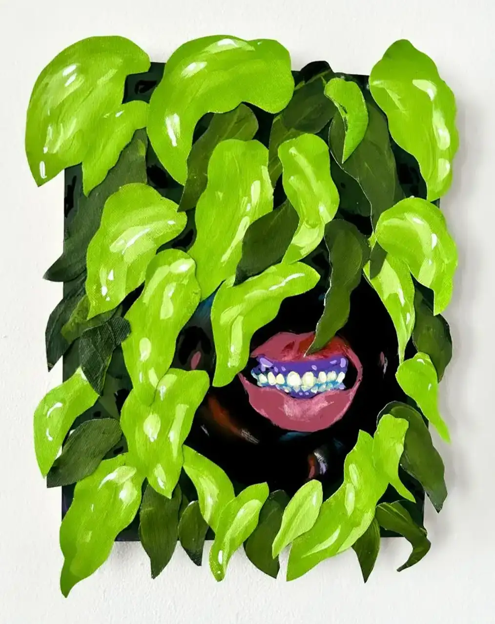 painting of a face in the middle of vegetation