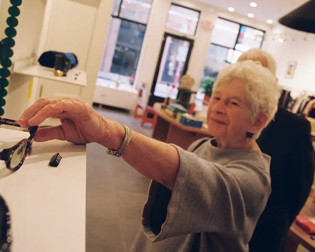 adult woman taking glasses from a shelf