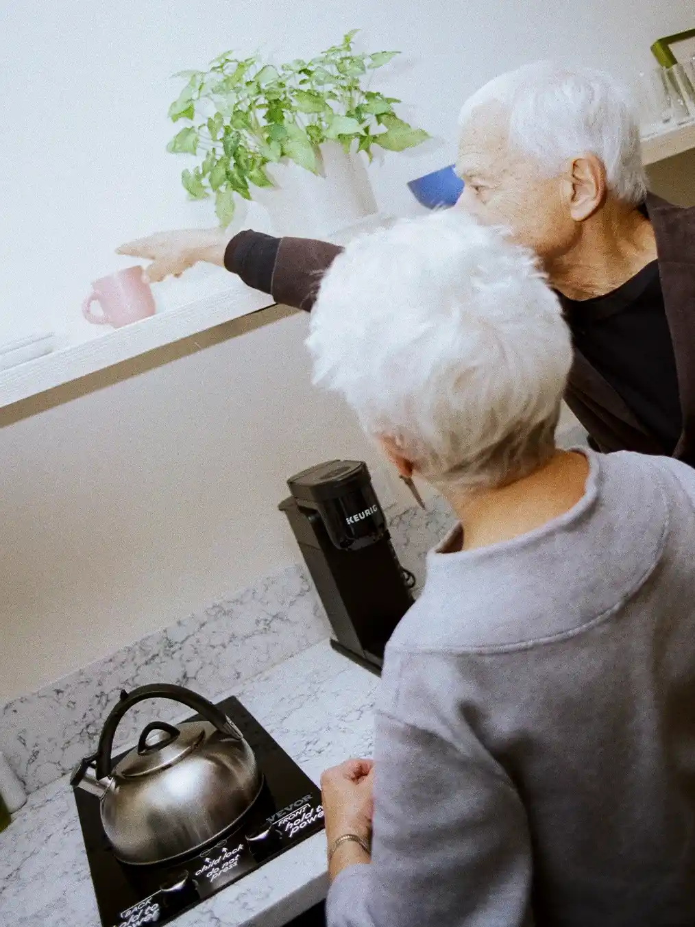two elderly people in the kitchen