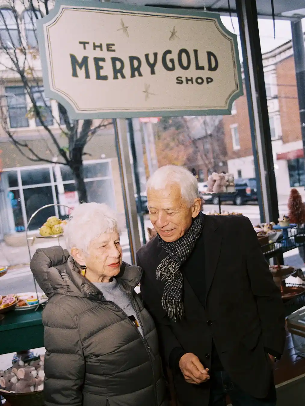 two adults posing and smiling at the camera