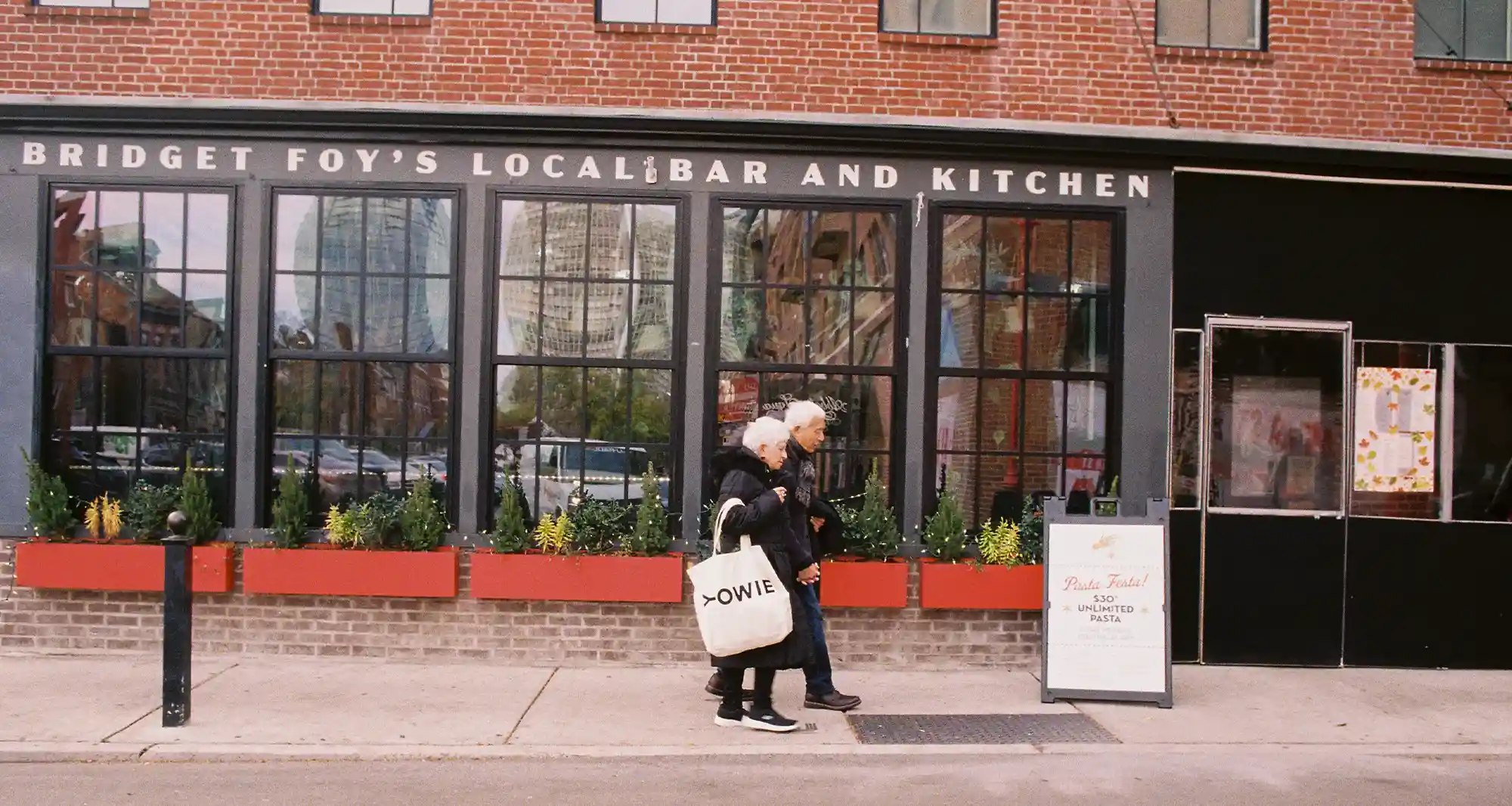 couple of adults walking on the street