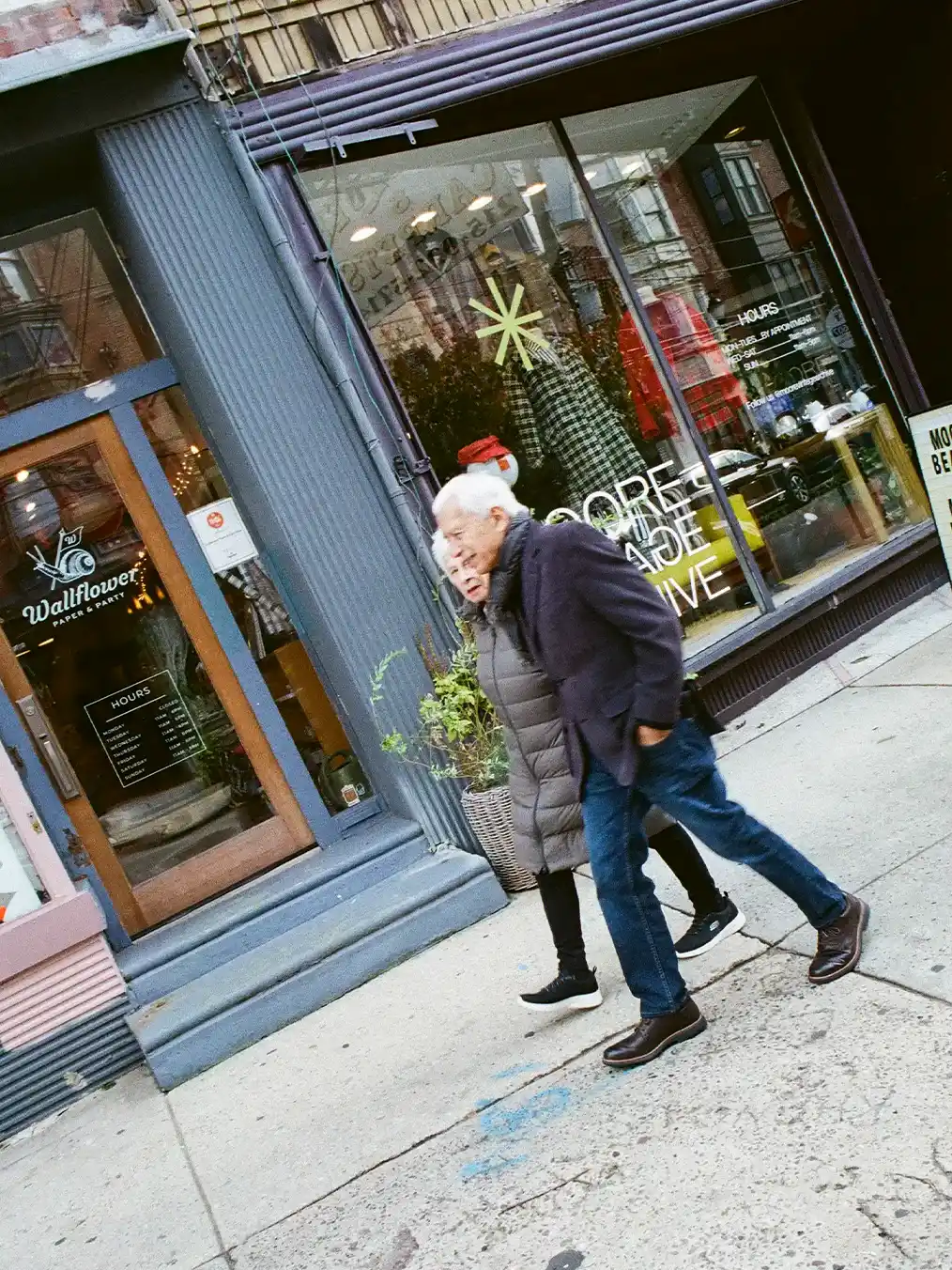 two seniors holding hands walking in the city