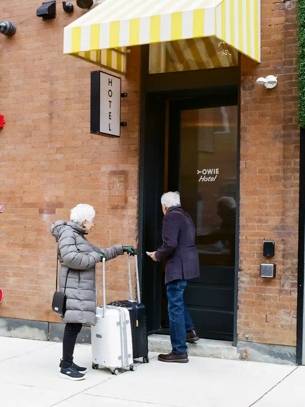 elderly couple entering a store