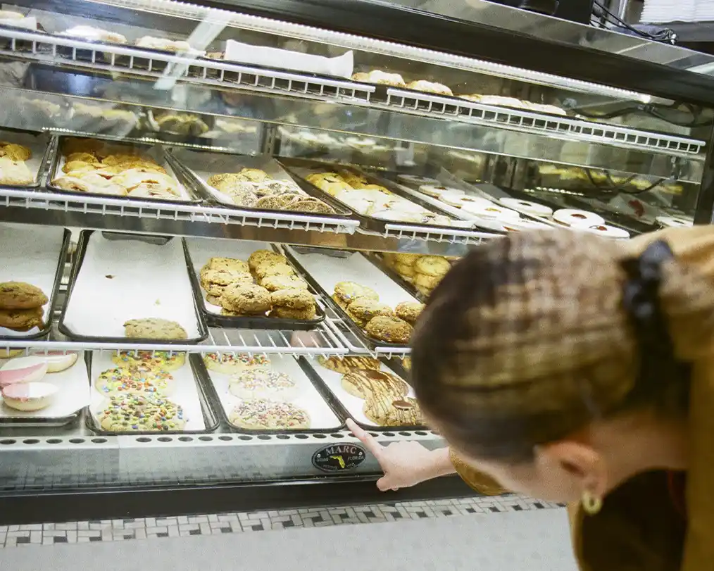 woman choosing a bun from the bakery