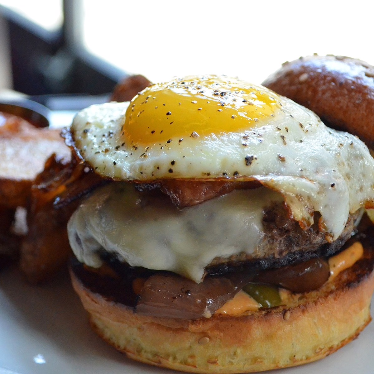 MilkBoy South Street burger topped with a sunny side up egg.